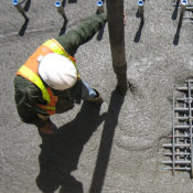 man pouring concrete mix outside