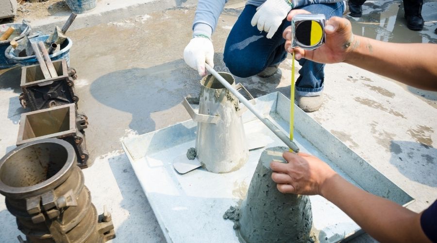 people conducting a concrete slump test at a jobsite